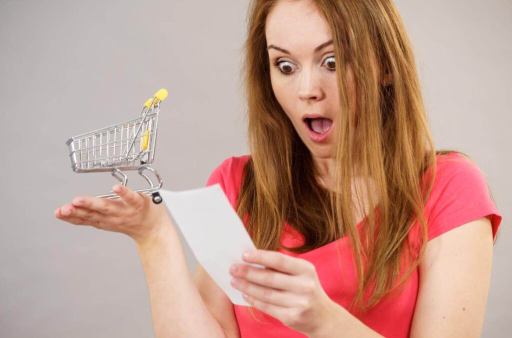 woman surprised looking at paper pushcart