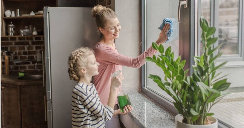 woman and child cleaning windows