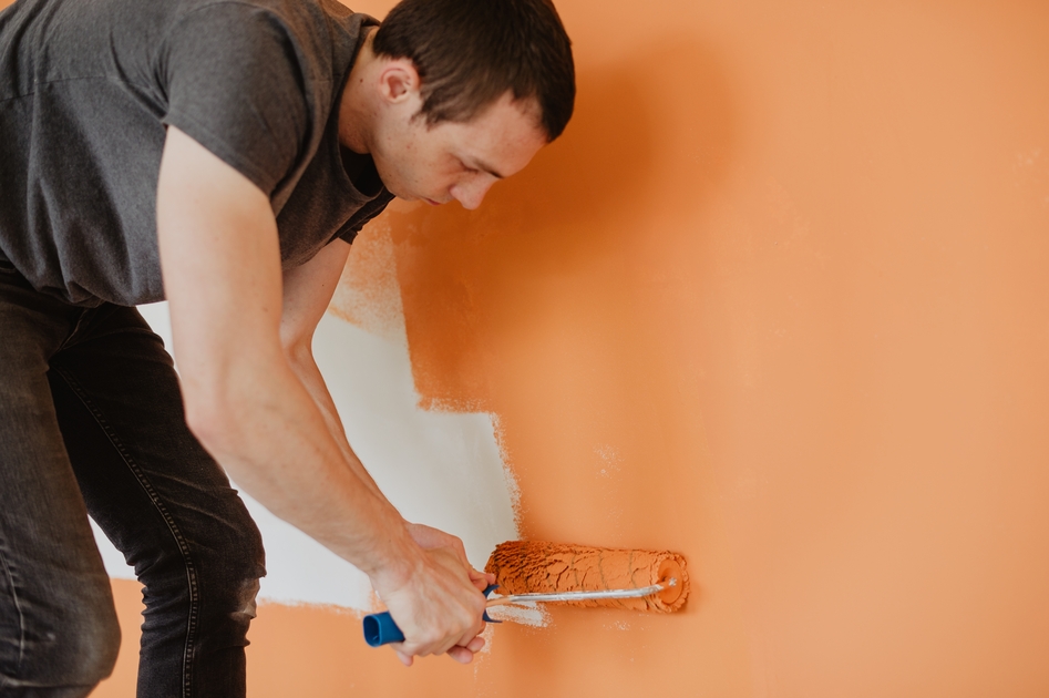 man painting elastomeric paint